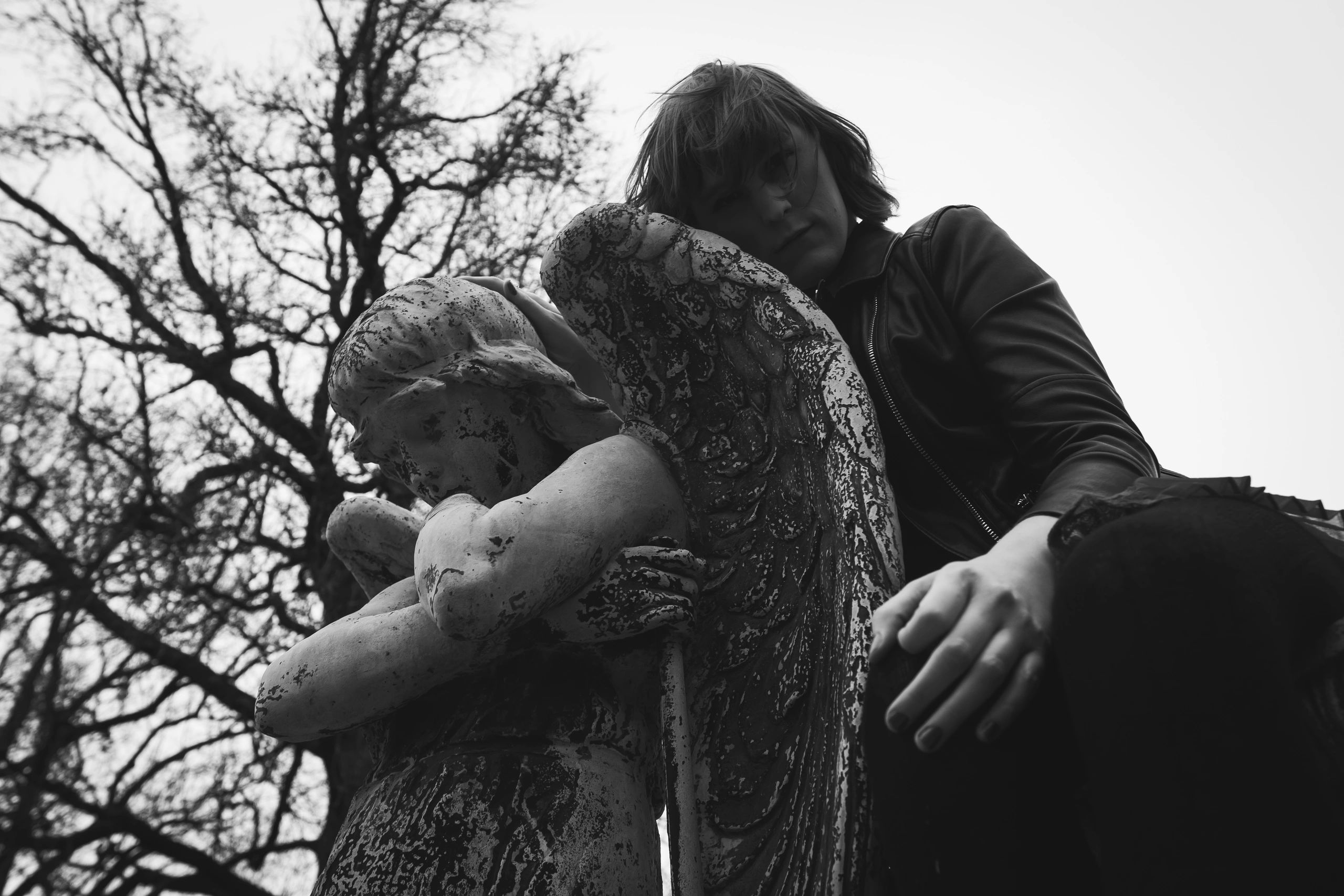 Portrait leaning on stone statue